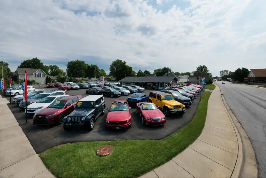 Fast Lane Autos used car lot with vehicles displayed near the roadside