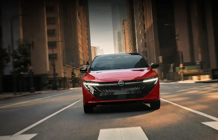 Red 2026 Nissan Sentra driving through the city