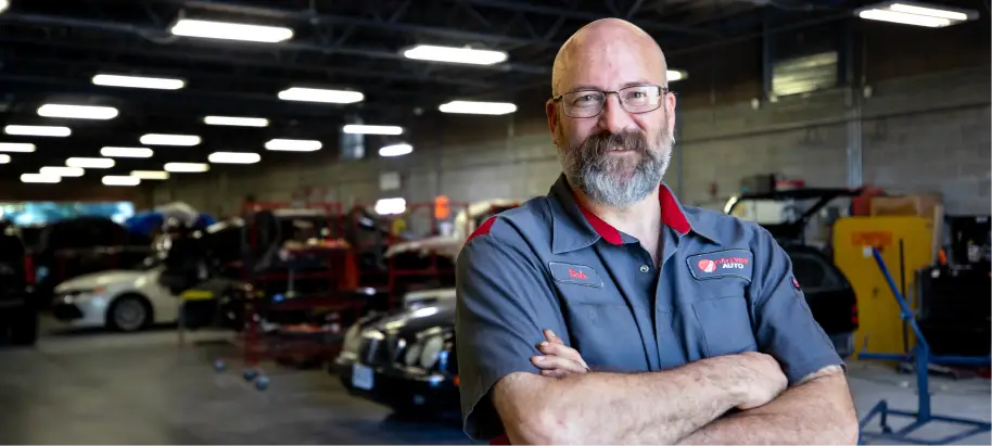 Certified technician working in auto repair shop.