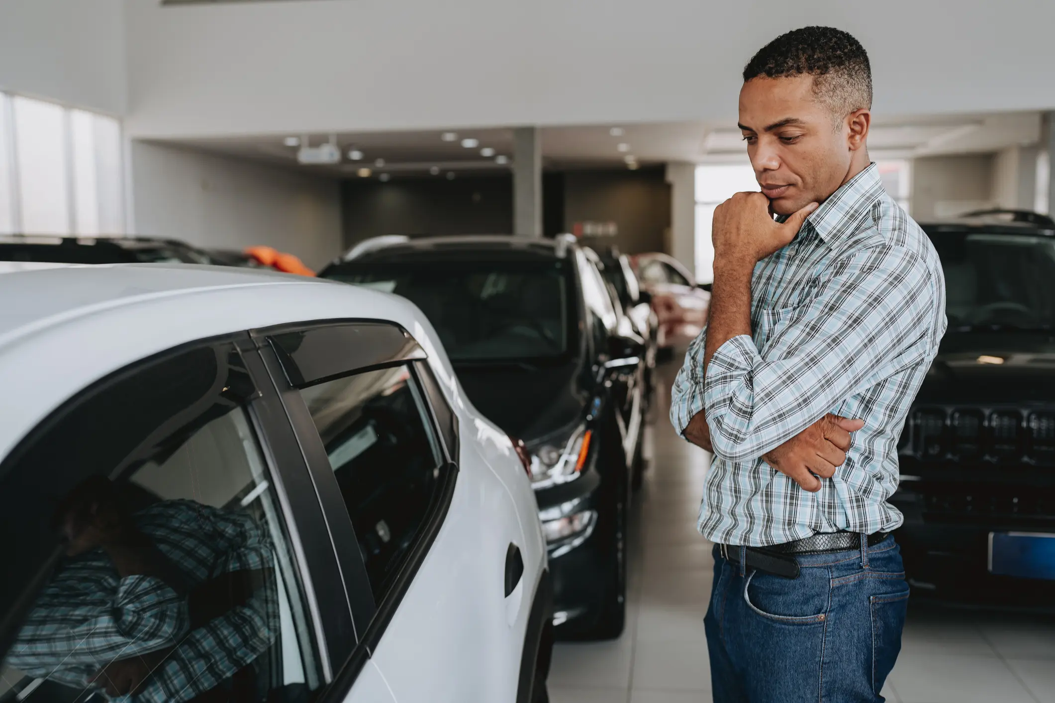 Man examining a white SUV