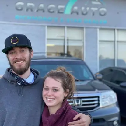 Happy Grace Auto Sales customer with a new red vehicle in Richmond, VA