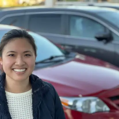 Happy Grace Auto Sales customer with a new red vehicle in Richmond, VA