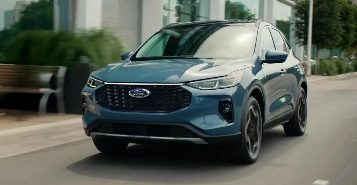 Blue Ford Escape driving through the city