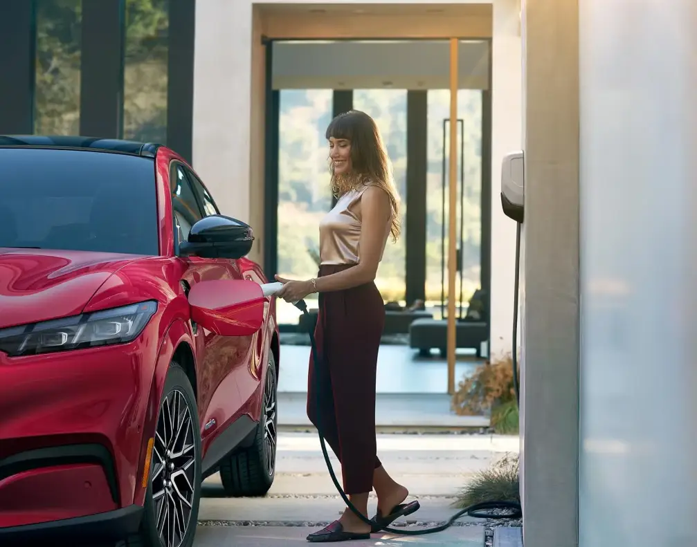 Ford SUV charging at a home EV station