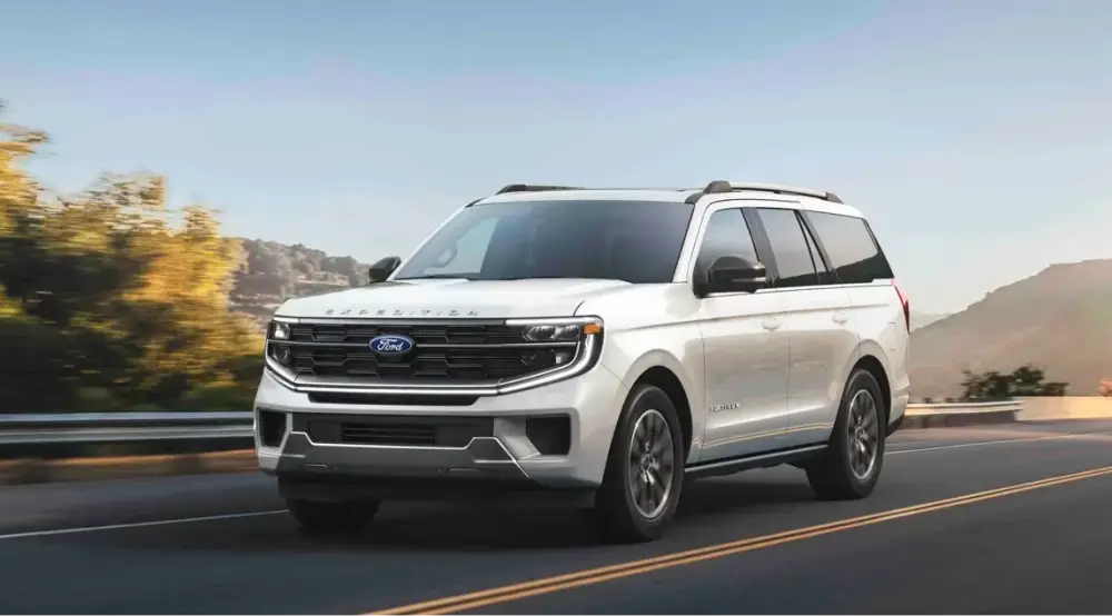 White Ford SUV driving on a mountain road