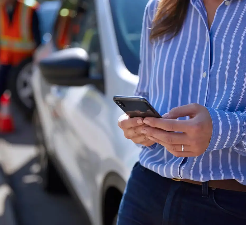 Person reviewing vehicle damage assessment on a phone