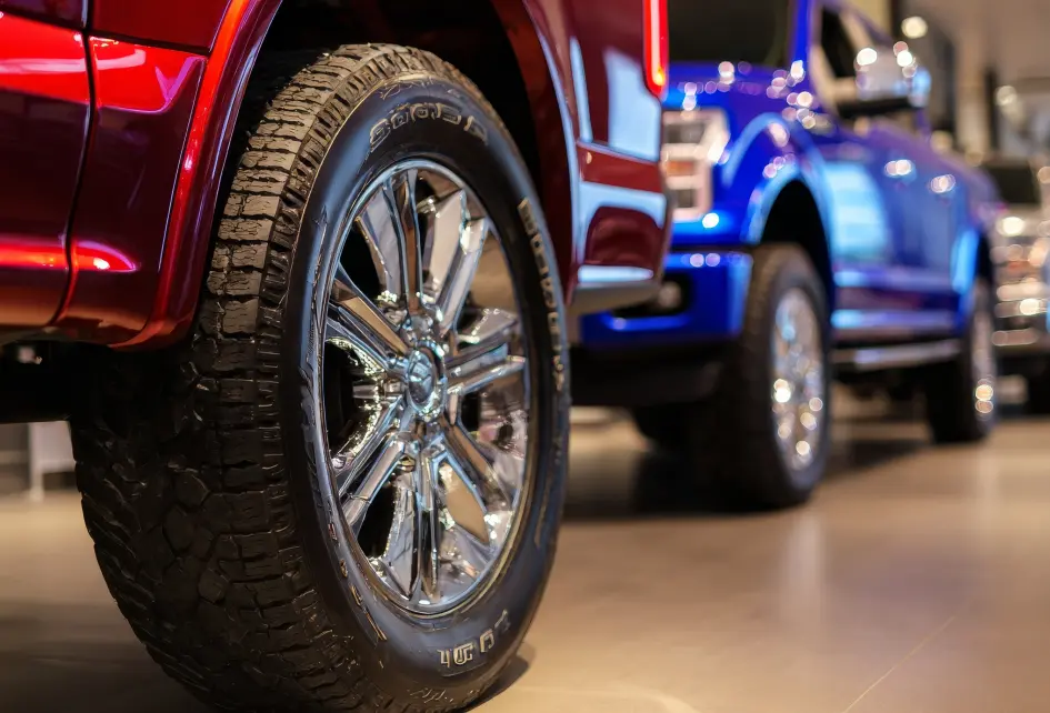 Red and blue used pickup trucks at Hayes Motor Company in Lubbock, TX