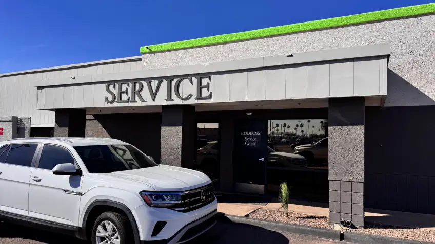 Ideal Cars service center exterior with vehicle parked outside in Mesa, AZ.