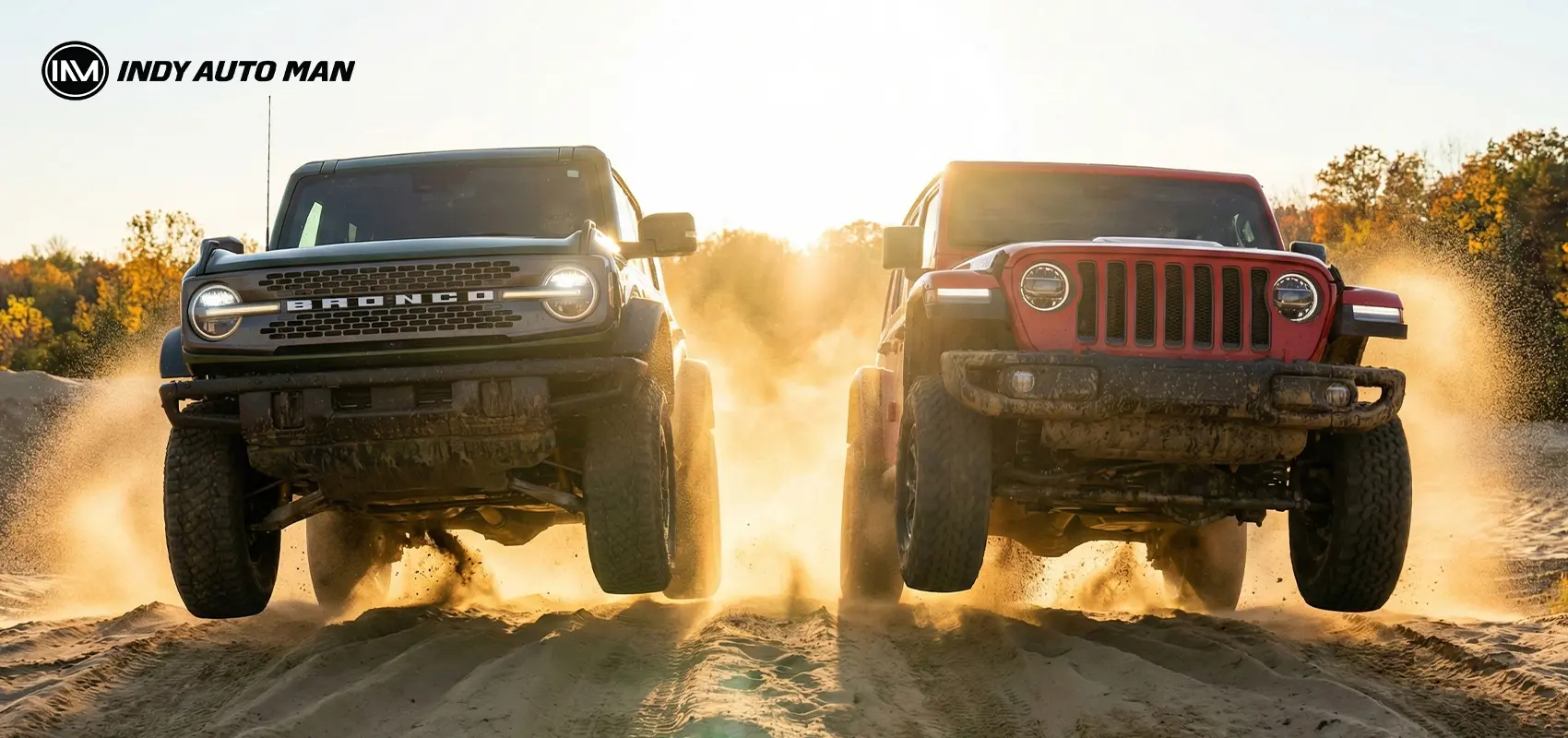 Yellow and gray Ford Bronco side by side