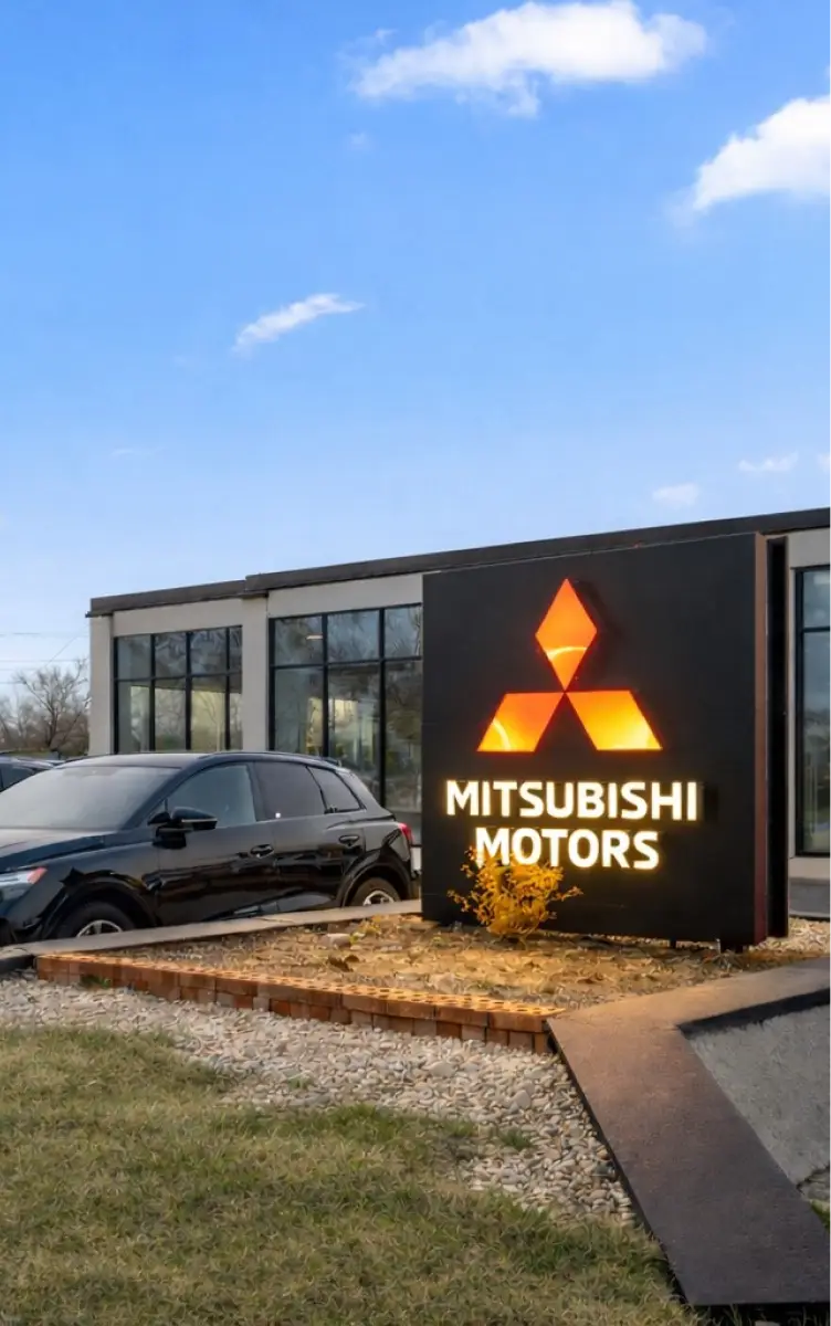 Jidd Motors Mitsubishi dealership exterior with illuminated Mitsubishi Motors sign.