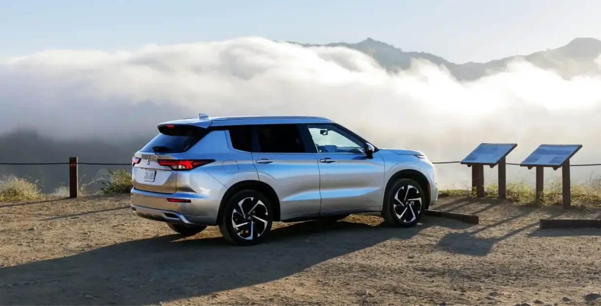 Mitsubishi vehicle parked overlooking mountains