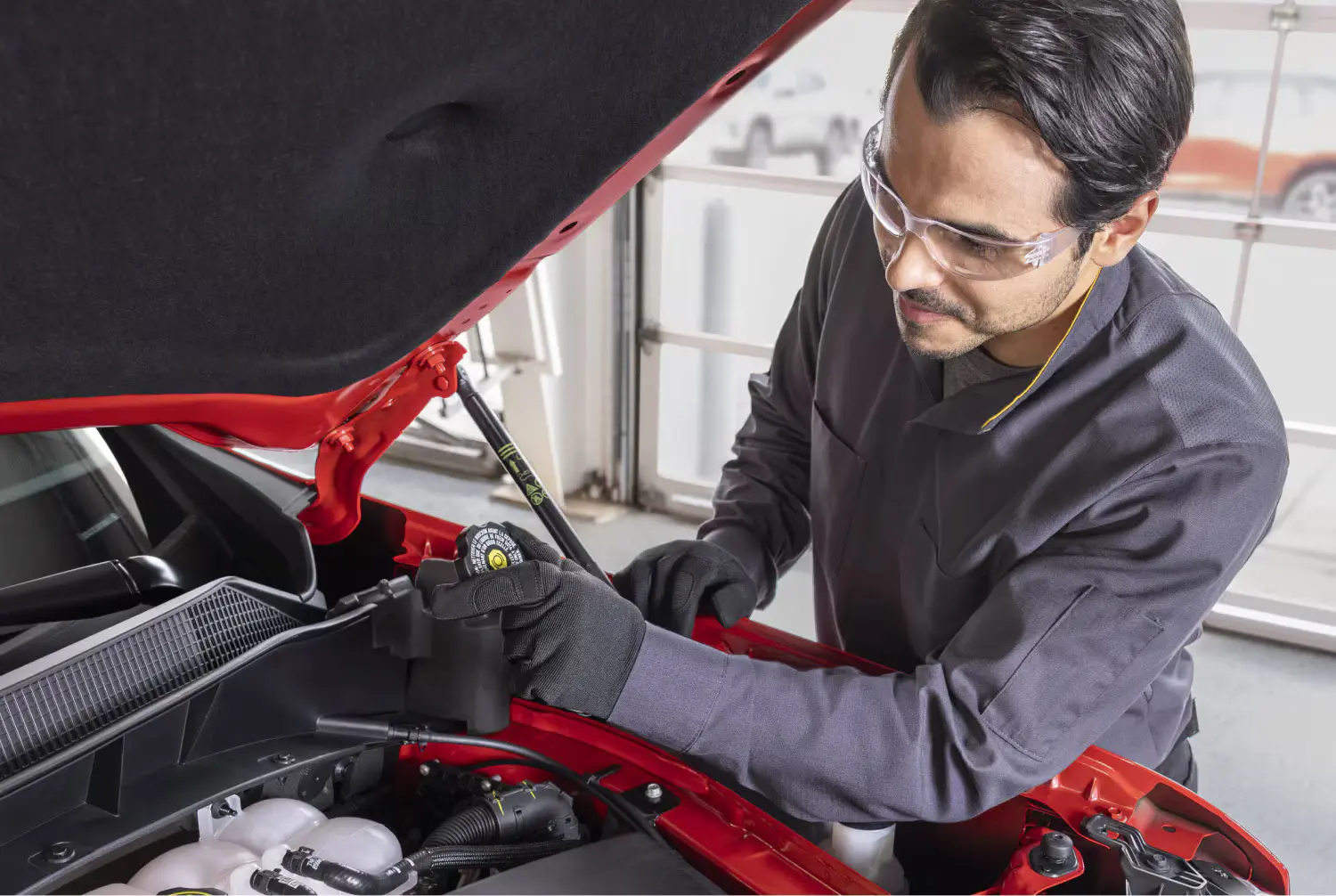 A man servicing a car.