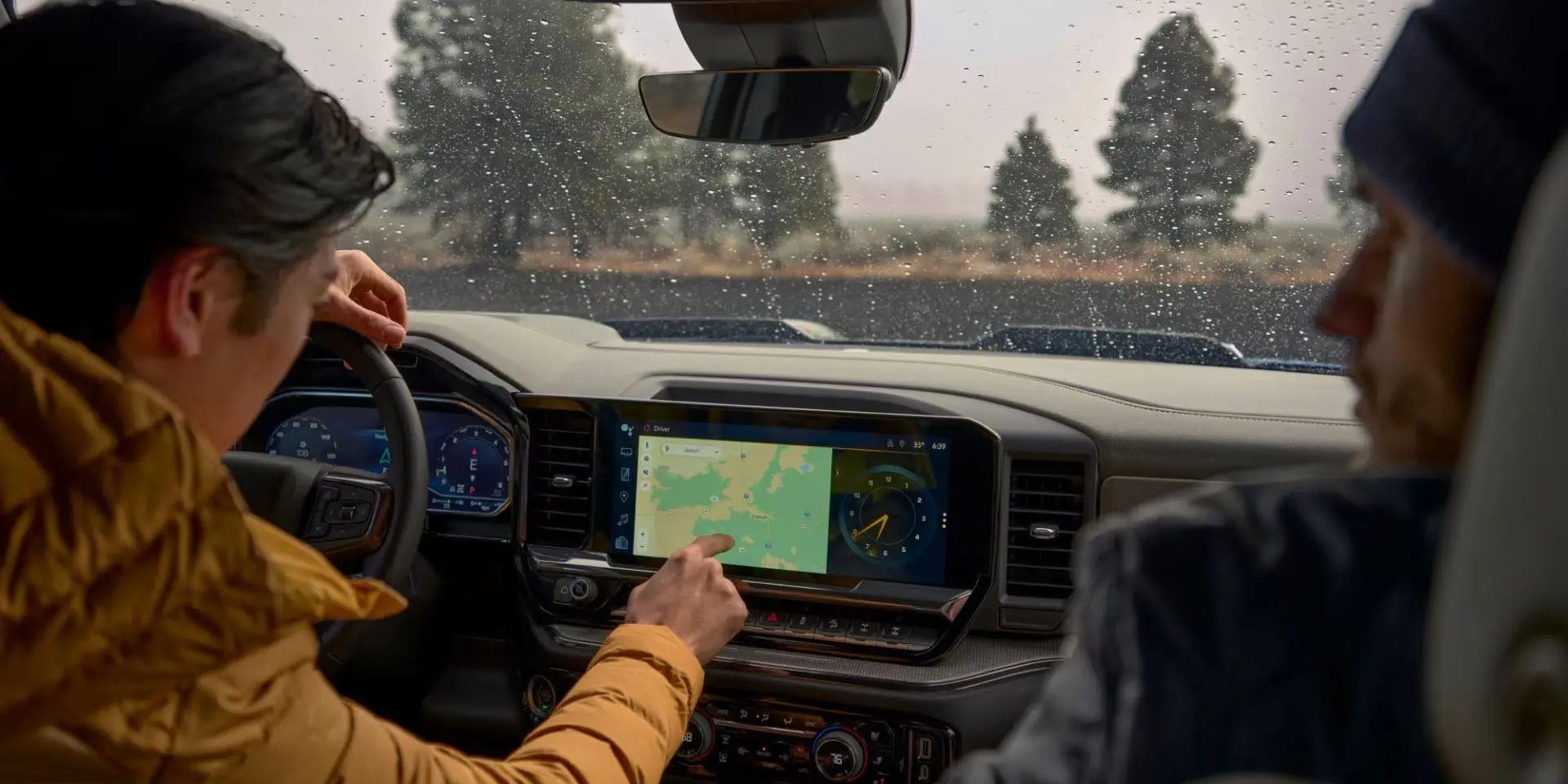 a 2025 silverado 1500 with 2 people inside using navigation