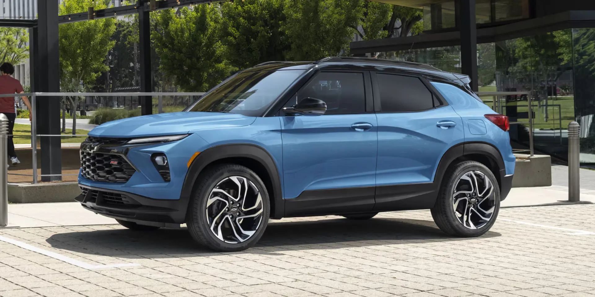 A blue trailblazer sitting parked.
