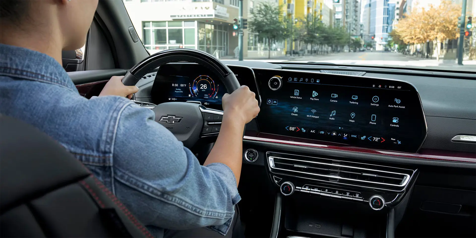 A woman sitting in the driver seat of a traverse.
