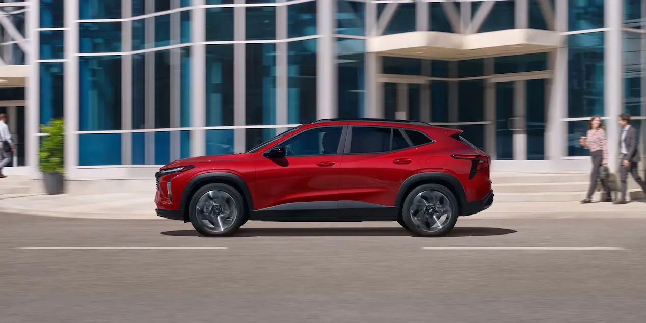 A red suv driving on the road.