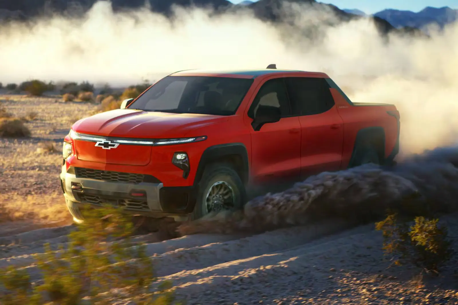 A red truck driving off-road.