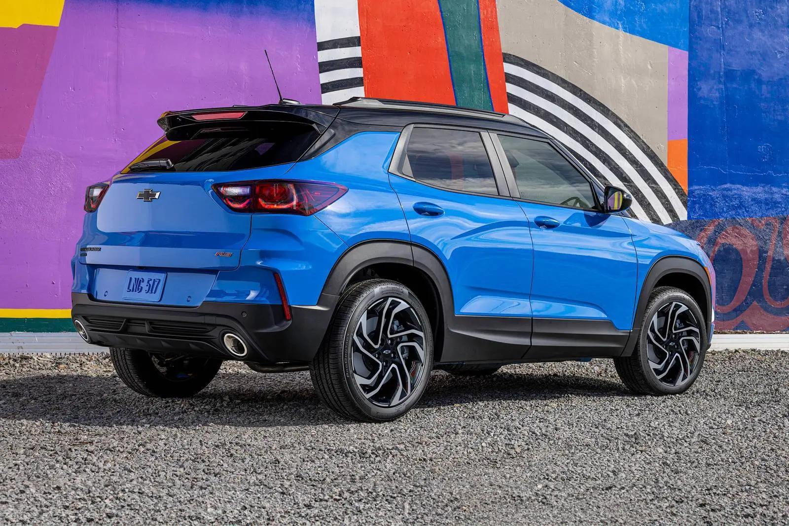 A blue suv sitting parked.