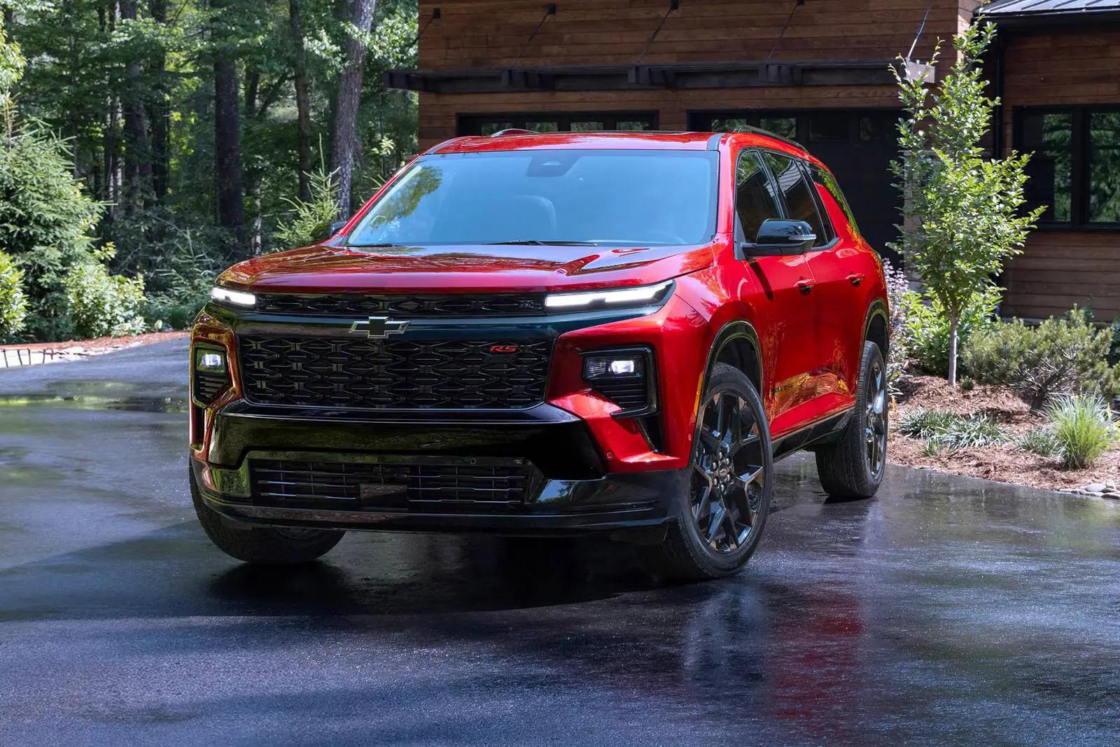 red chevy traverse parked at a house
