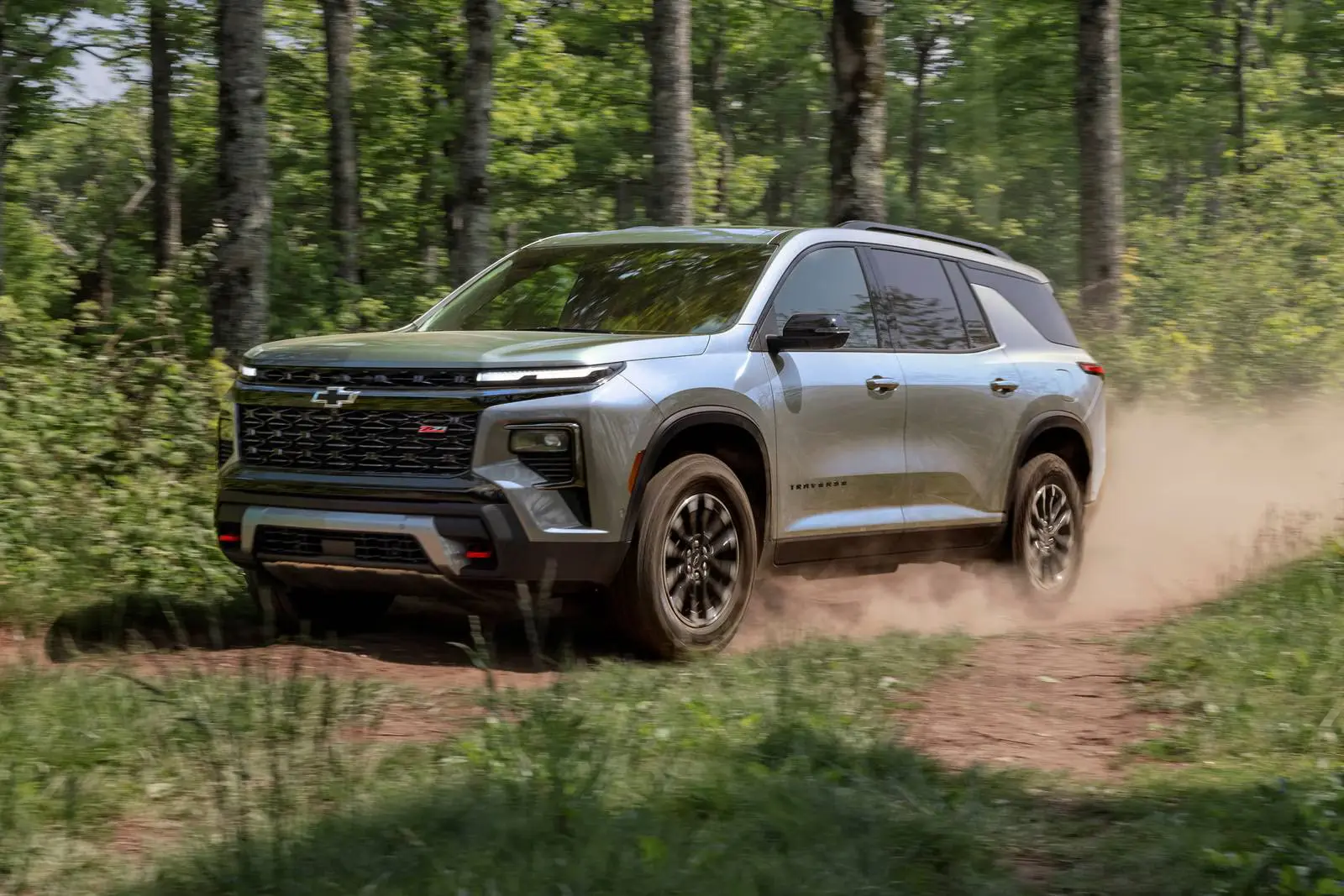 A green suv driving off-road.