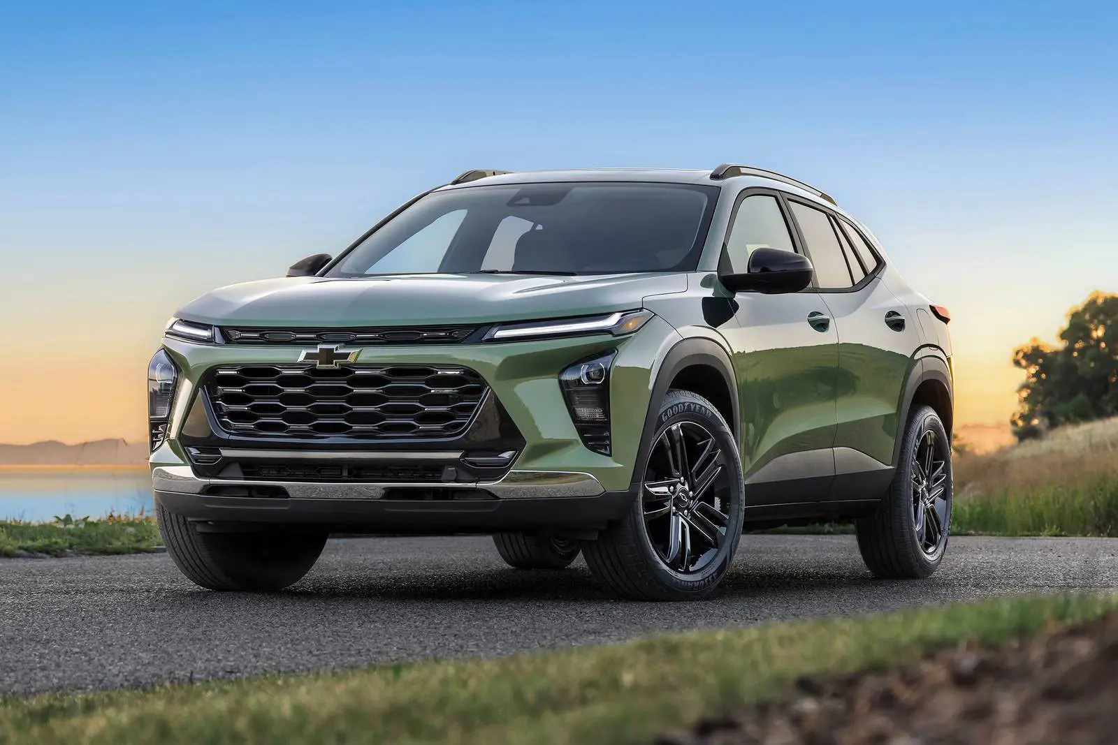 A green suv sitting parked on the road.