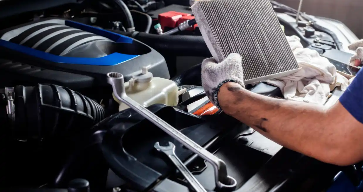 Mechanic inspecting a cabin air filter during AC and heating service