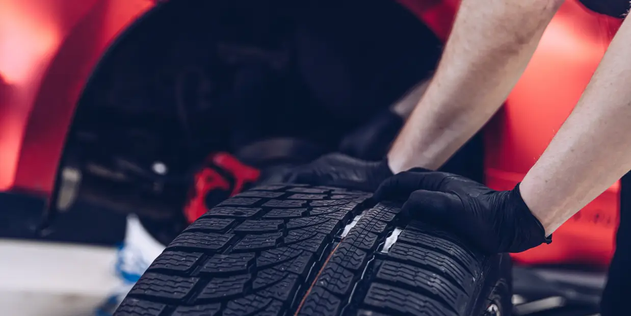 Technician handling tires during tire service in Colorado Springs