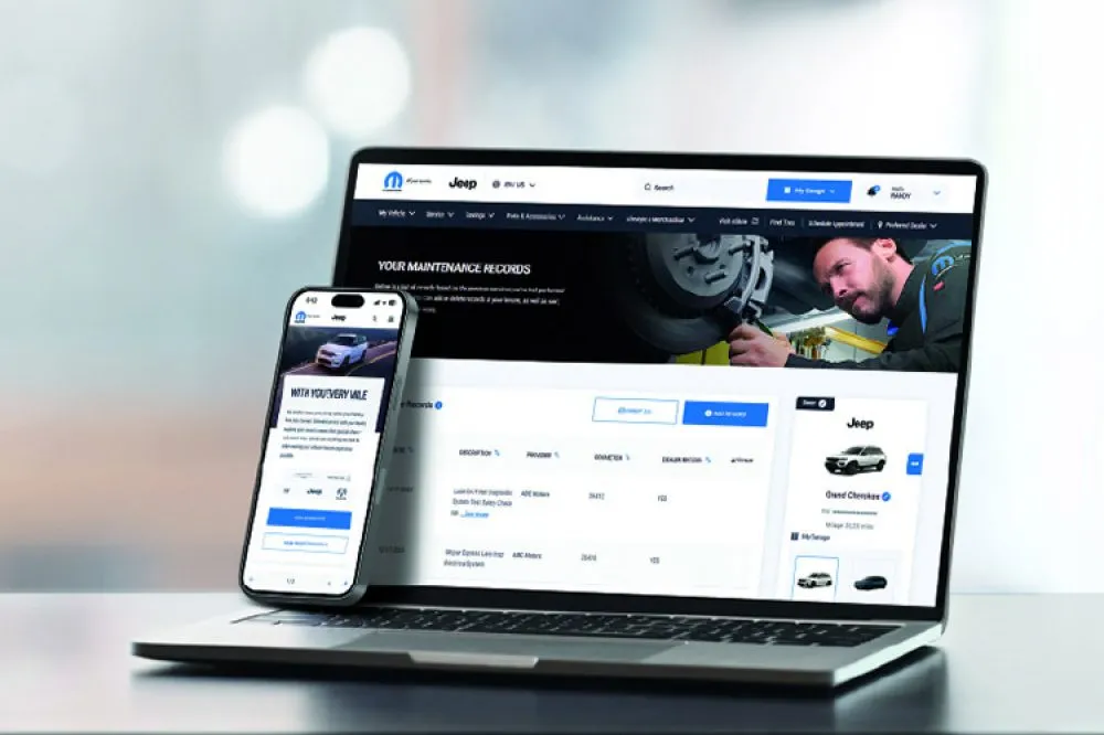 Driver using the Uconnect app to access connected vehicle features near Webster, NY