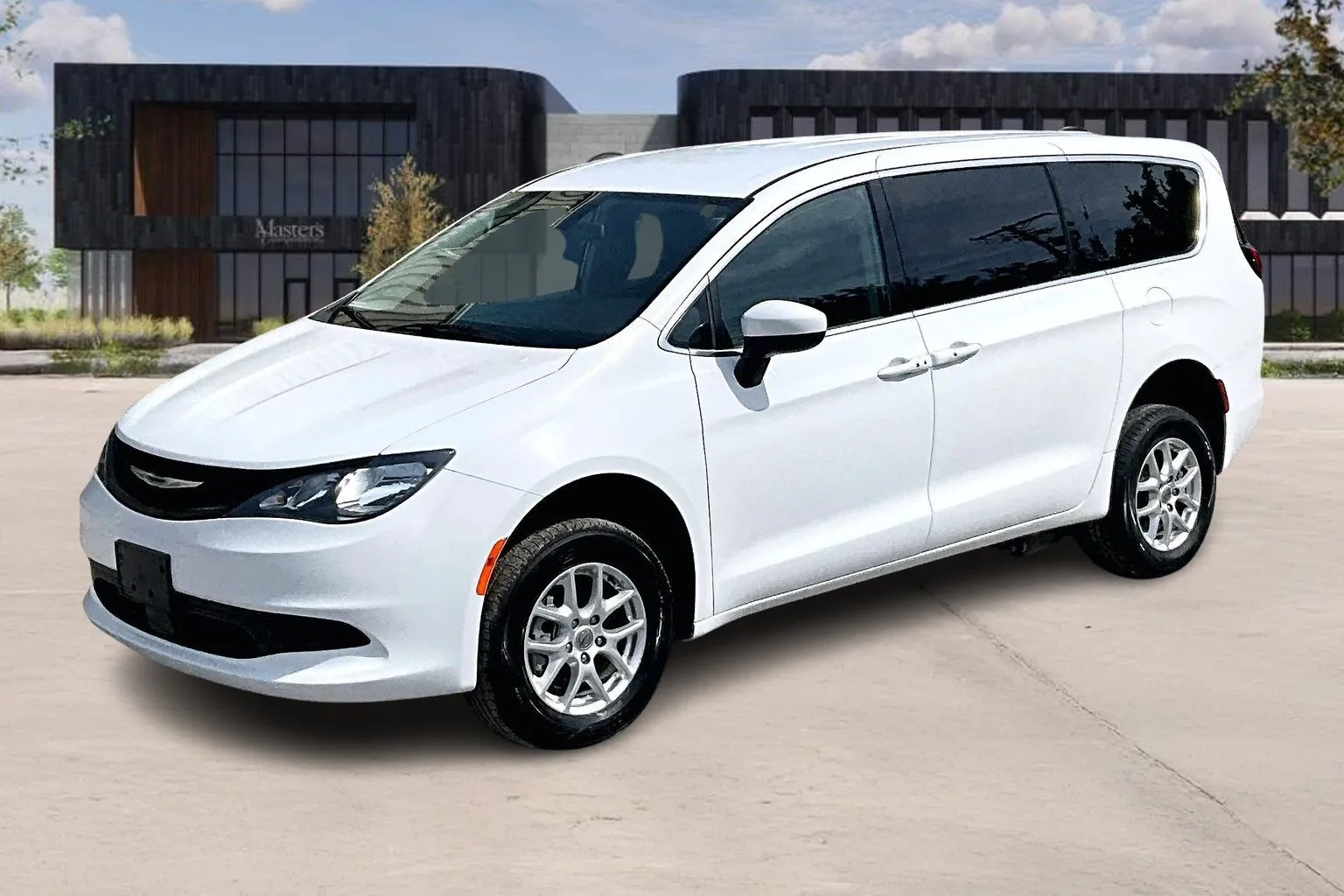 White Chrysler wheelchair accessible minivan, front three-quarter view