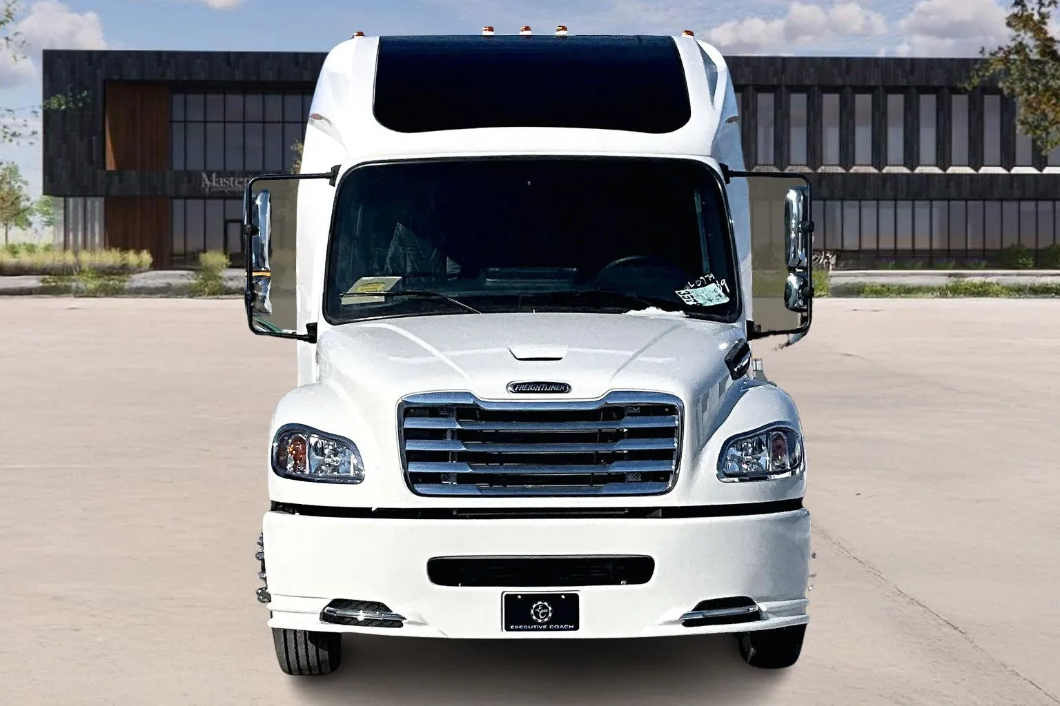 Front view of a white Freightliner M2 bus at Master's Transportation