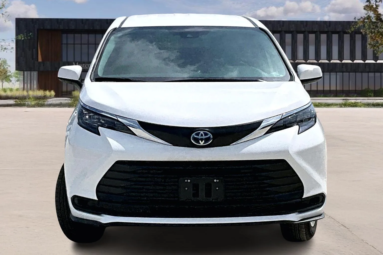 Front view of a white Toyota Sienna wheelchair accessible minivan at Master's Transportation