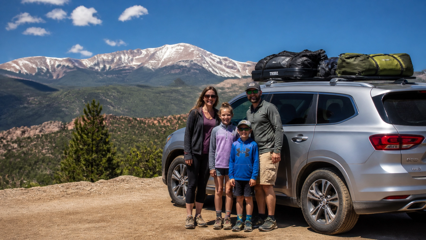 Family packed for a Colorado road trip with a mountain backdrop
