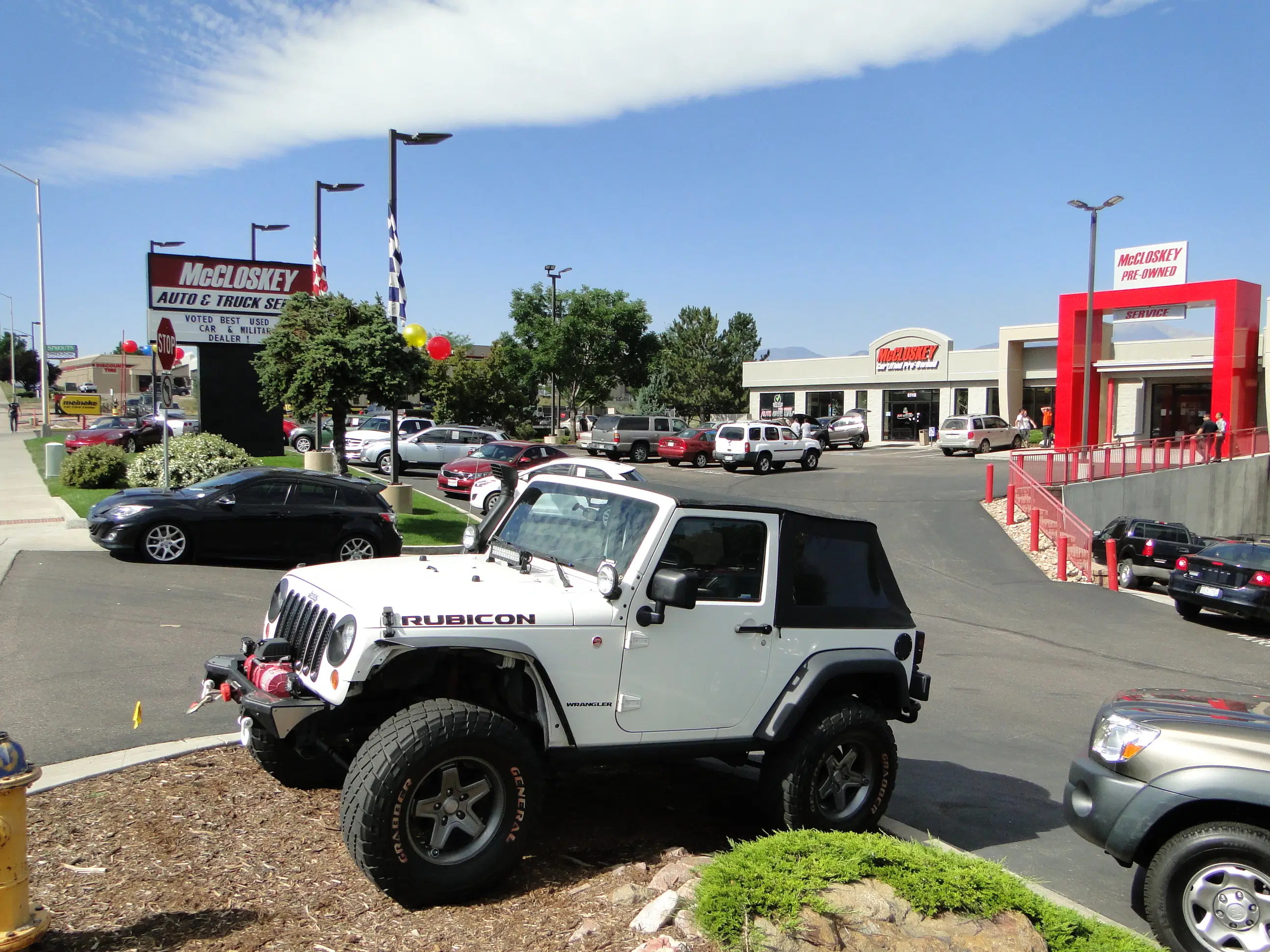 A white Jeep Wrangler Rubicon on display at McCloskey Motors, showcasing the ideal vehicle for Colorado's off-road and winter driving conditions.