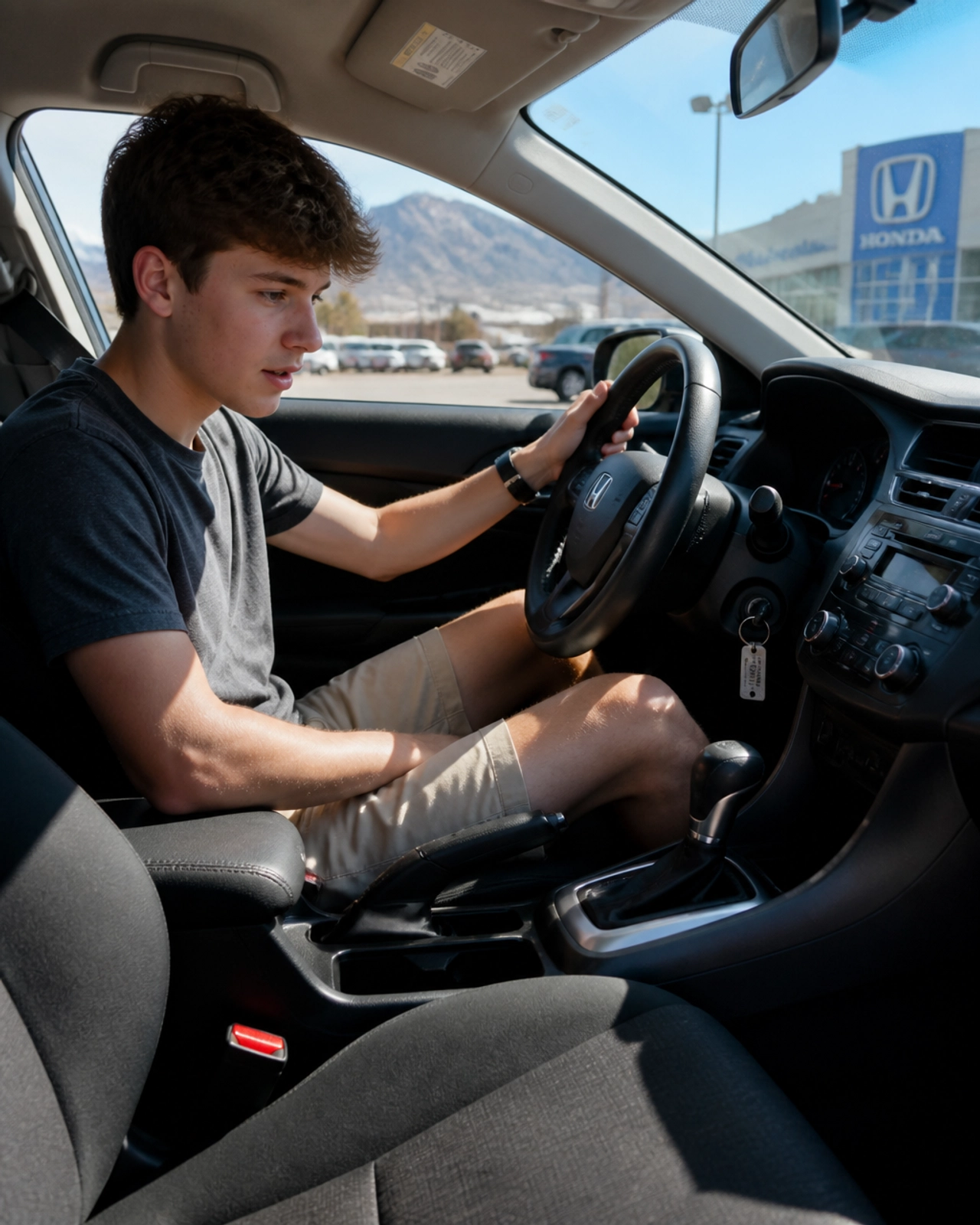 A young driver sitting in a used car exploring the features and interior