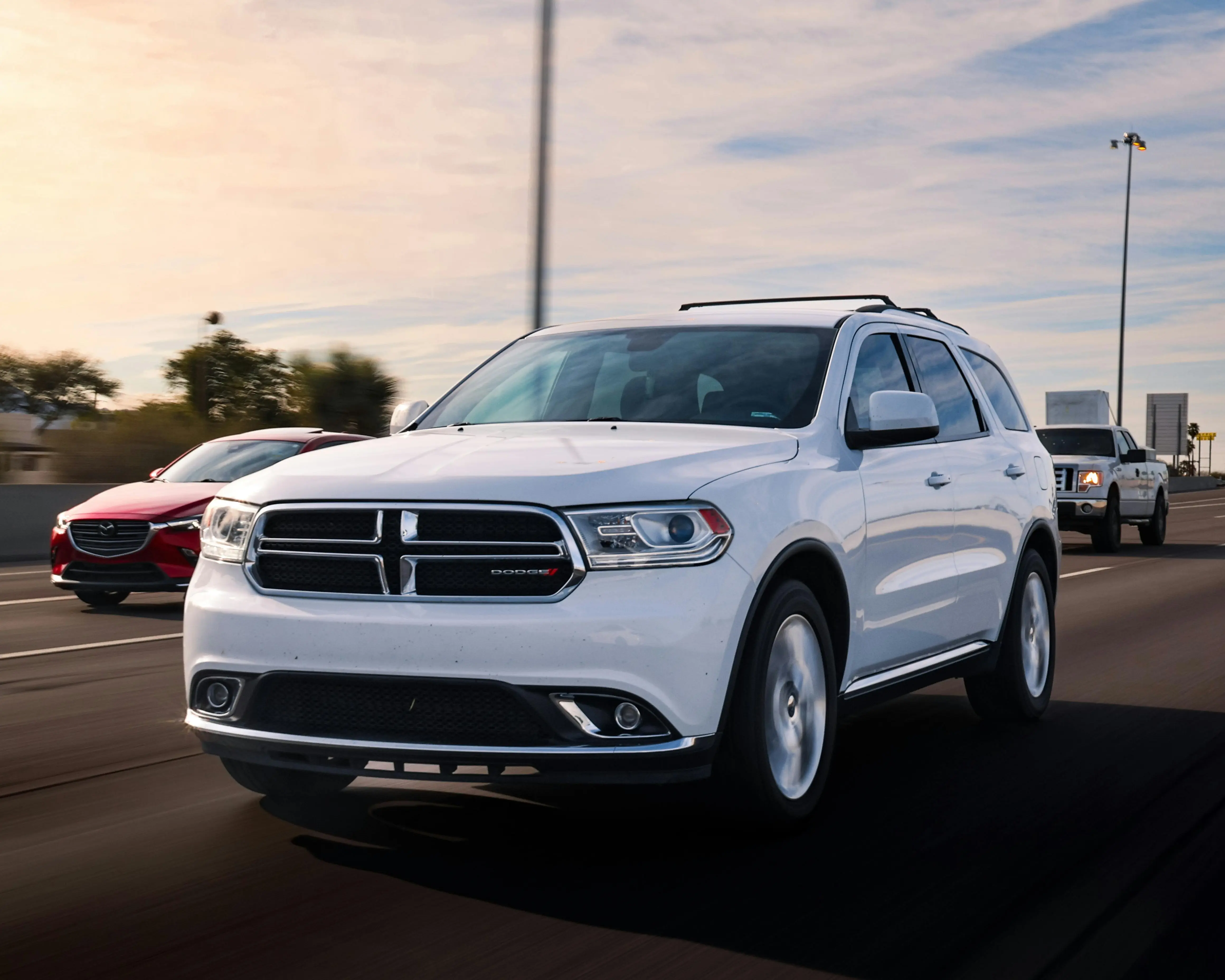 White Dodge Durango driving on the highway
