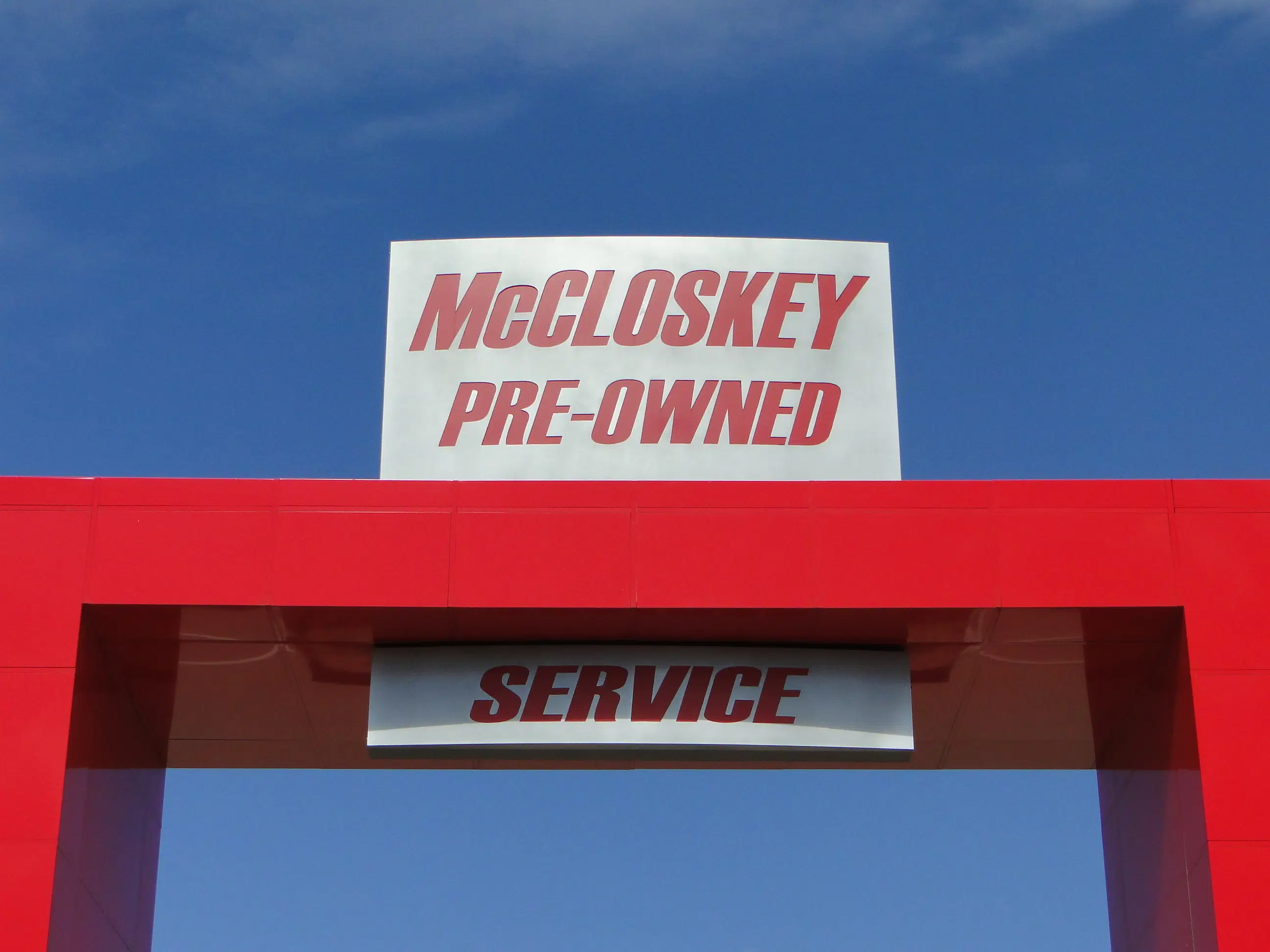 The main entrance of McCloskey Motors, an award-winning dealership known for its commitment to customer service and quality pre-owned vehicles.
