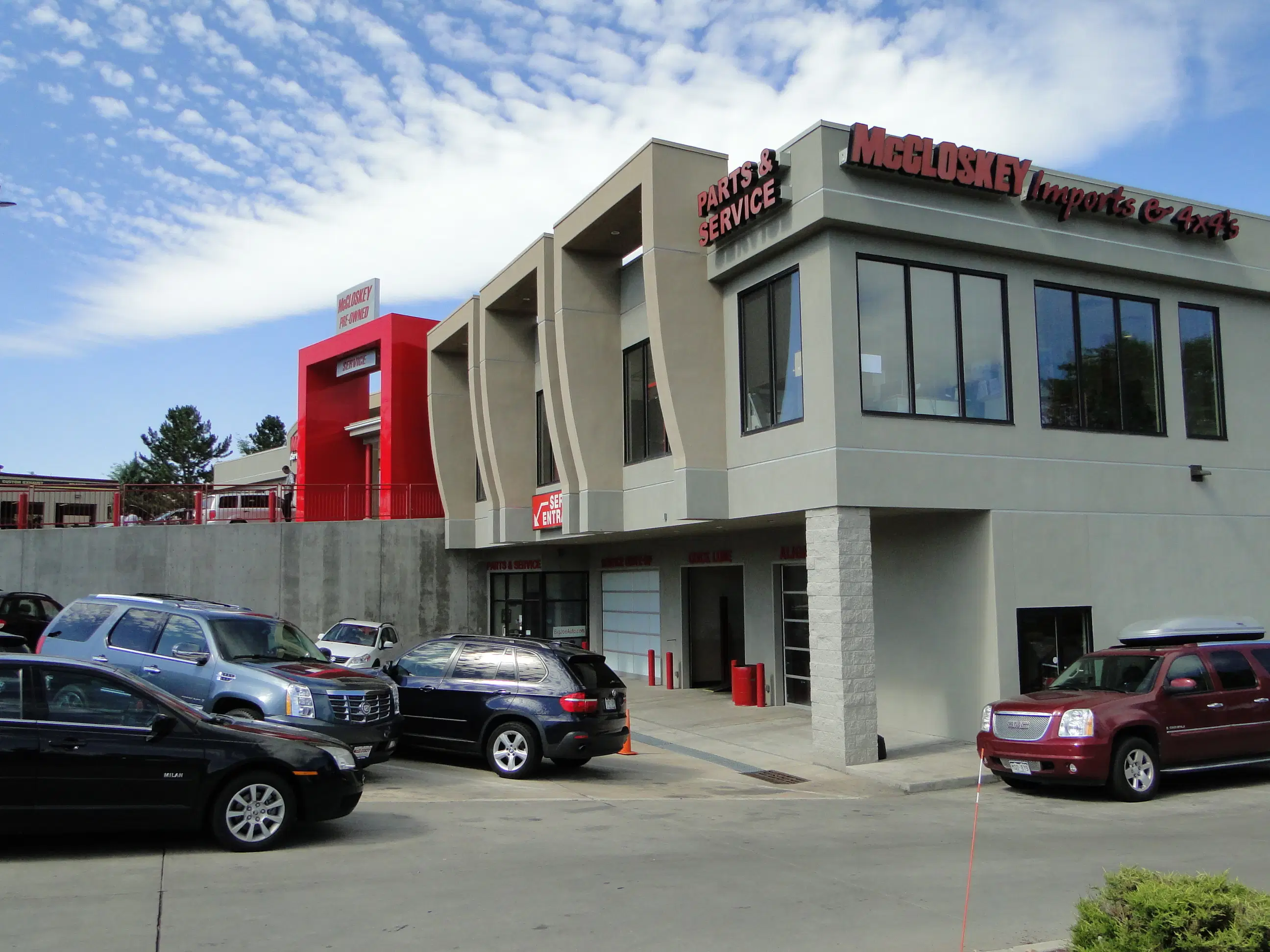 The exterior of the McCloskey Imports & 4x4’s service center with several SUVs parked in the lot.