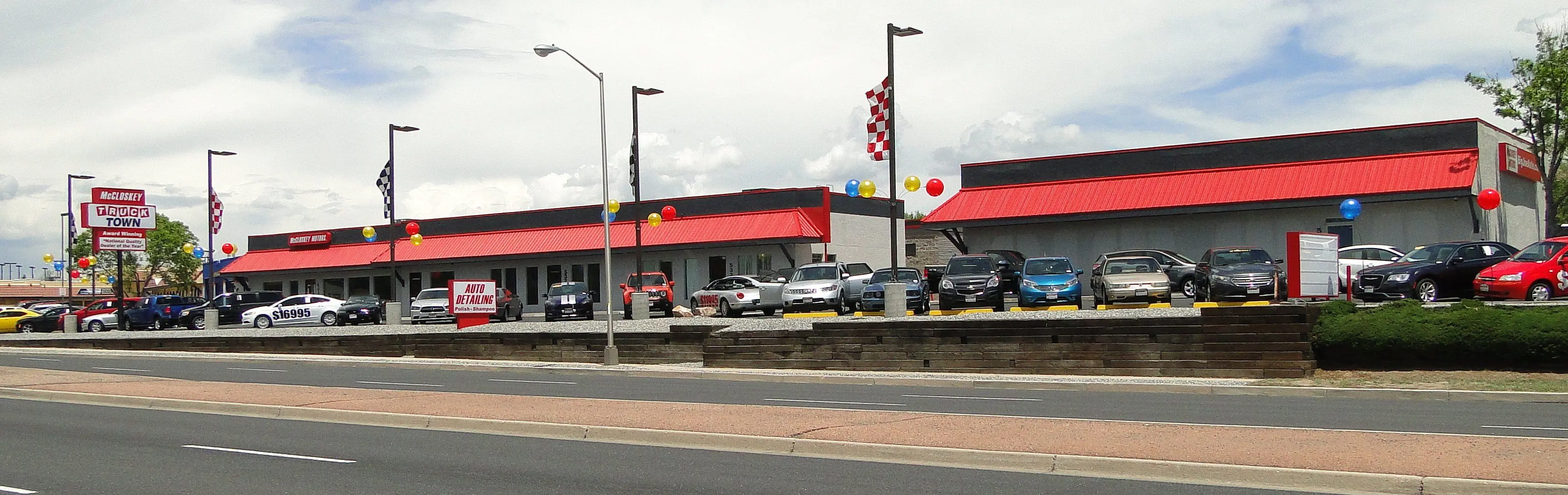 Wide-angle view of the McCloskey Truck Town dealership in Colorado Springs, featuring a large selection of trucks, SUVs, and cars at McCloskey Truck Town in Colorado Springs CO
