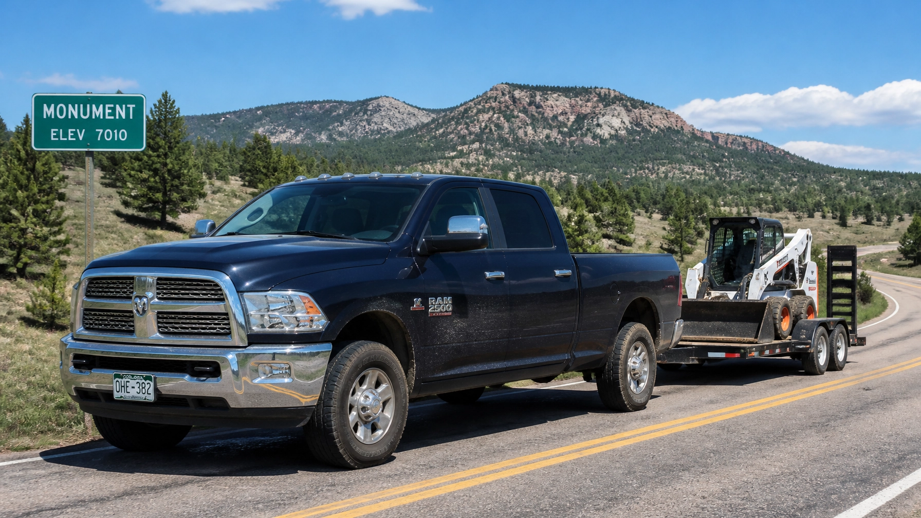 2014 Ram 2500 heavy-duty pickup truck towing a trailer at McCloskey Truck Town in Colorado Springs CO