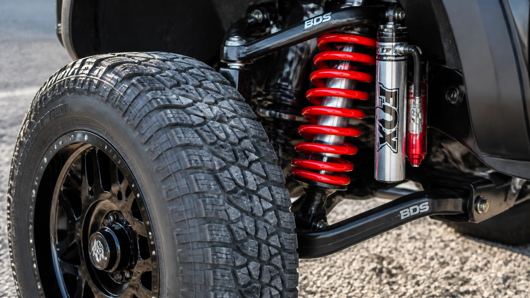 Detailed view of a heavy-duty off-road suspension system at McCloskey Truck Town in Colorado Springs CO