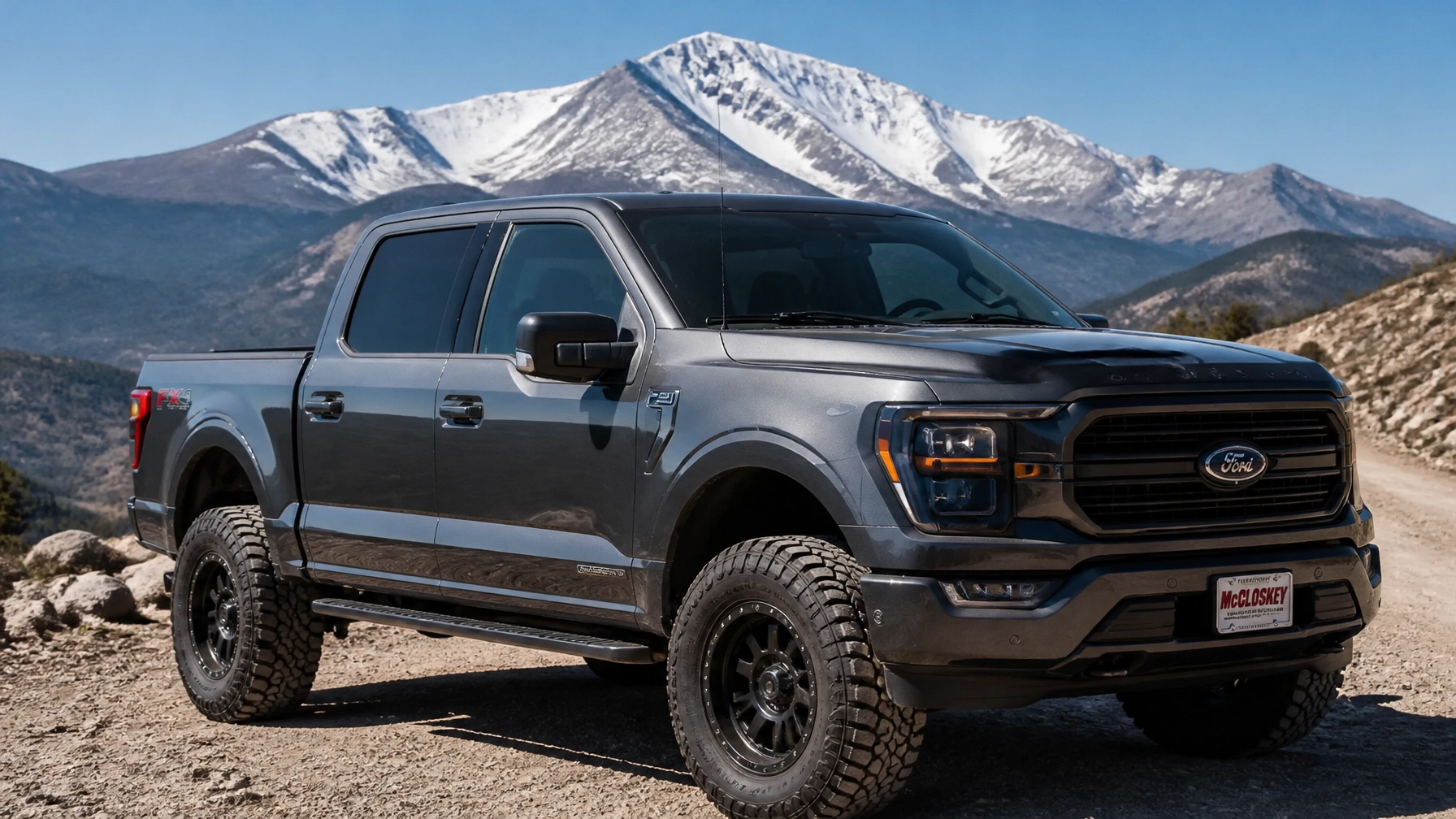 Lifted Ford F-150 driving on a gravel mountain shelf road near Pikes Peak at McCloskey Truck Town in Colorado Springs CO