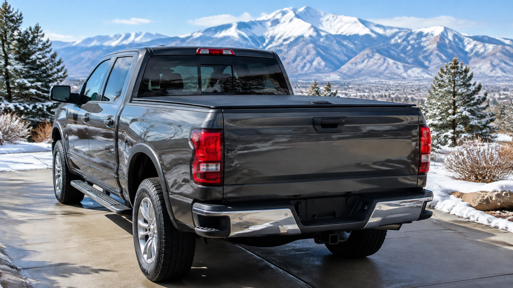 Pickup truck with a closed locking tonneau cover and latched tailgate in a Colorado winter setting