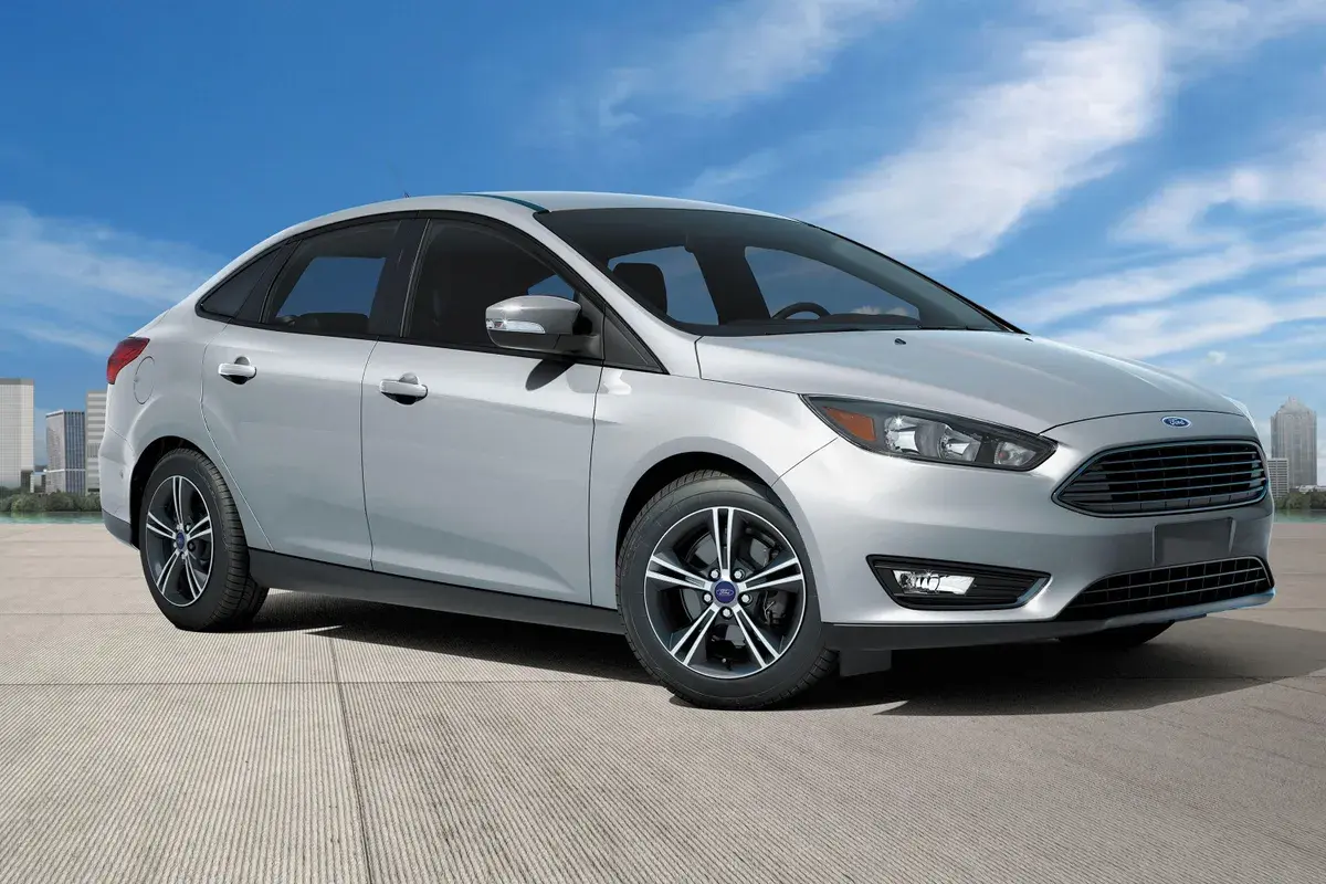 Silver Ford Focus sedan front three-quarter view against a city skyline