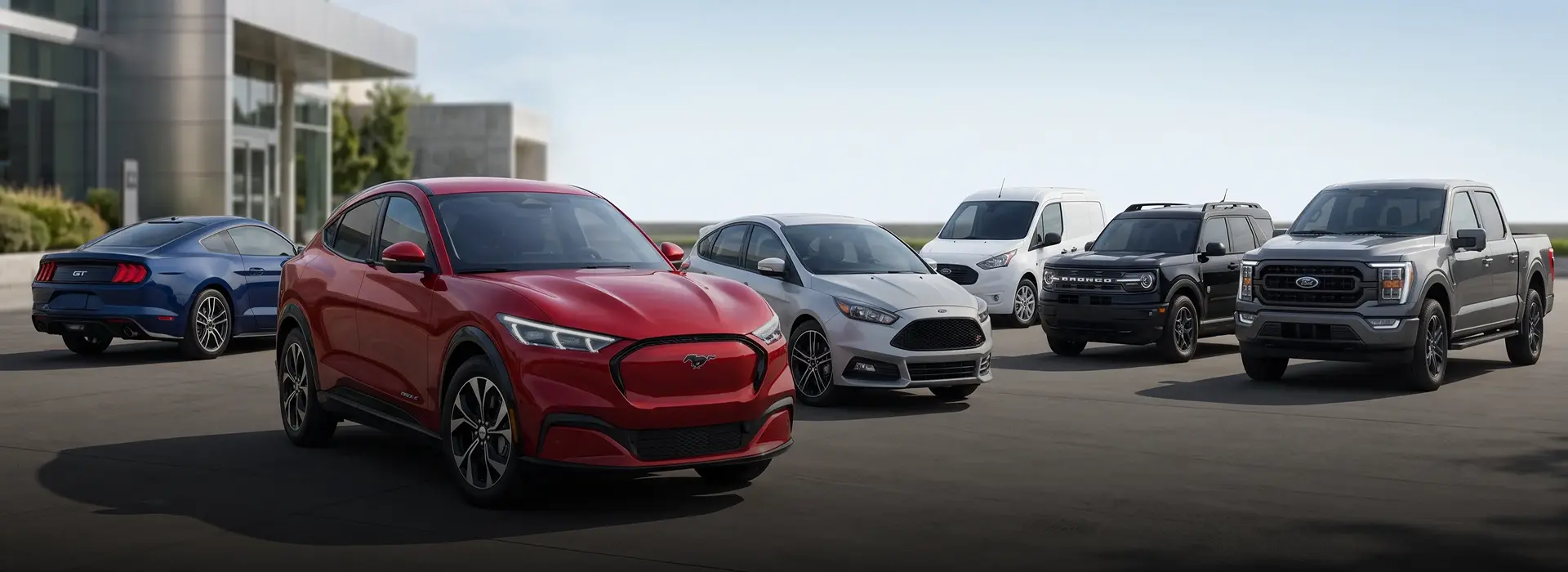 A lineup of used Ford trucks and cars parked at the Merit Auto Group dealership in Jacksonville, FL