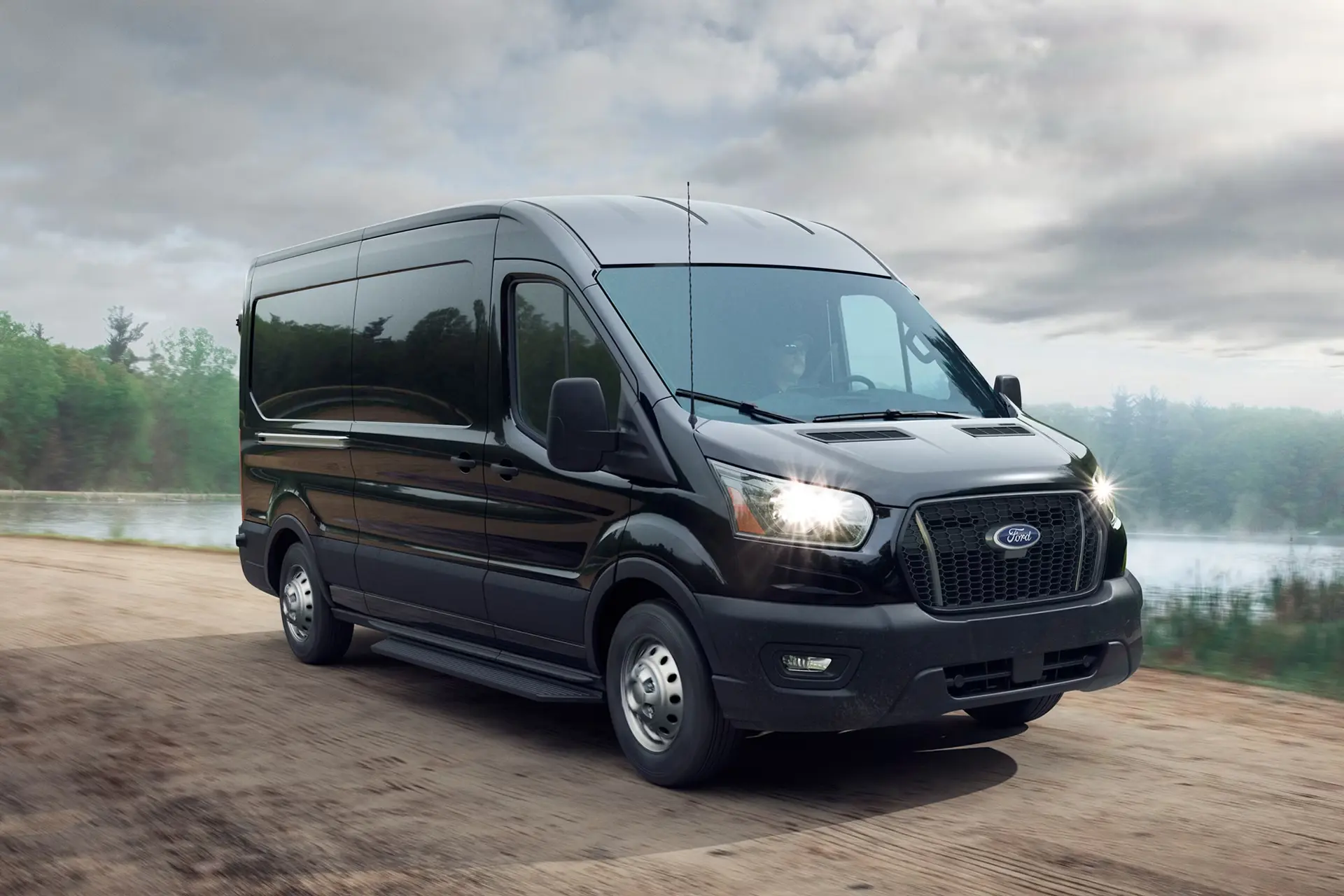 Black Ford Transit front three-quarter view on the road