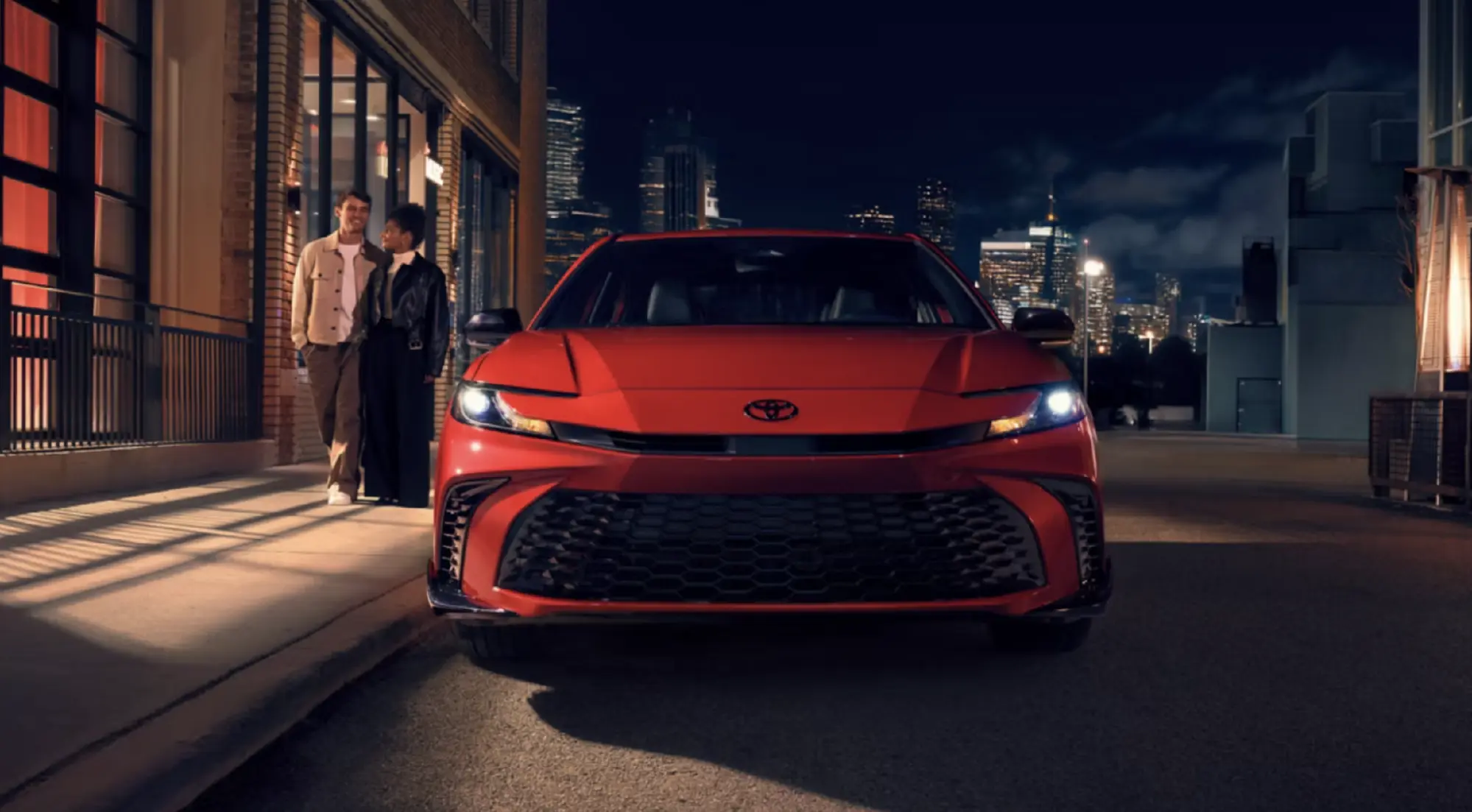 The 2026 Toyota Camry Nightshade shown in Supersonic Red. Options shown.