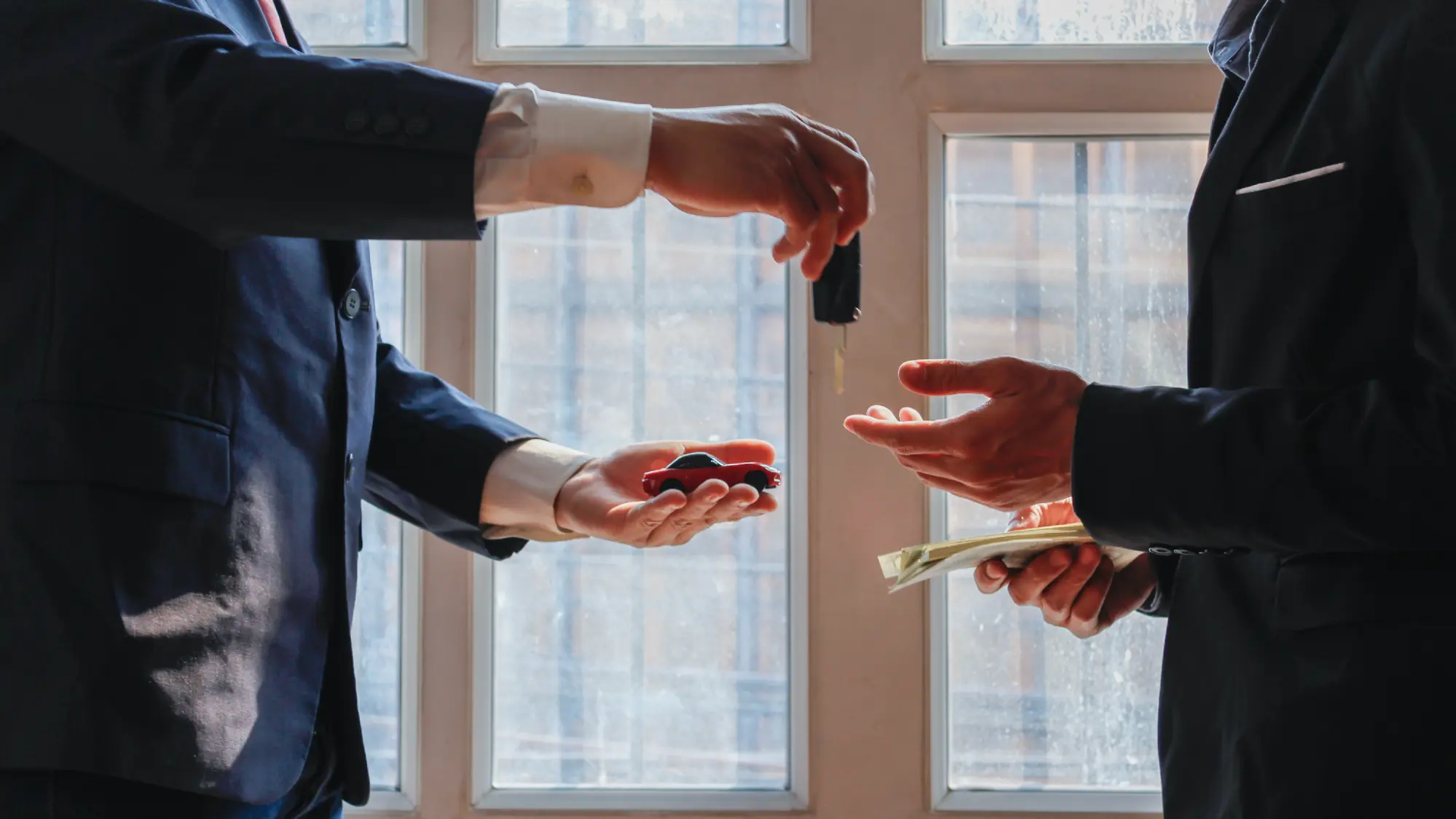 Two people trading car keys
