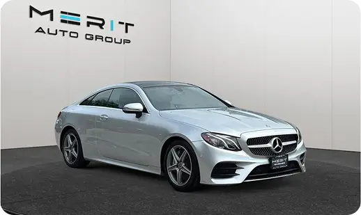 Silver Mercedes-Benz E-Class on a studio turntable, front three-quarter view