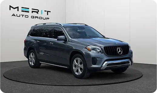 Gray Mercedes-Benz GLS full-size SUV on a studio turntable, front three-quarter view