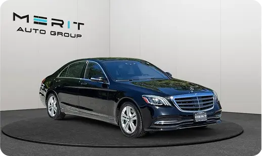 Black Mercedes-Benz S-Class sedan on a studio turntable, front three-quarter view